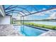 Screened-in pool boasts stunning water views, creating a serene and refreshing atmosphere to relax in at 3512 Cross Creek Pkwy, Parrish, FL 34219