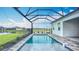 Screened-in pool with a tranquil water view, ideal for swimming laps and soaking up the sun at 3512 Cross Creek Pkwy, Parrish, FL 34219