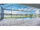 Screened-in pool overlooking a serene lake and neighboring homes at 3512 Cross Creek Pkwy, Parrish, FL 34219