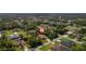 Aerial view of a suburban home surrounded by lush greenery in a residential neighborhood at 3524 Brownwood Ter, North Port, FL 34286