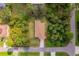 Aerial view of a well-maintained house with a lawn and trees in a neighborhood at 3524 Brownwood Ter, North Port, FL 34286