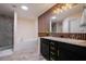 Bathroom features a soaking tub, walk-in shower, double vanity, and modern wood slat wall at 3524 Brownwood Ter, North Port, FL 34286