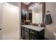 Modern bathroom featuring black vanity with gold hardware, and light accents at 3524 Brownwood Ter, North Port, FL 34286