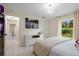 Bright bedroom featuring white decor, modern lighting and light wood floors at 3524 Brownwood Ter, North Port, FL 34286