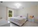 Neutral bedroom featuring a tufted headboard and bright natural lighting at 3524 Brownwood Ter, North Port, FL 34286