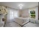 Bright bedroom with white tufted bed, chandelier, and plush decor at 3524 Brownwood Ter, North Port, FL 34286