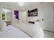 Bright bedroom featuring white decor, light wood floors and modern lighting at 3524 Brownwood Ter, North Port, FL 34286