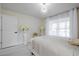 Bright bedroom featuring white decor, modern lighting, and light wood floors at 3524 Brownwood Ter, North Port, FL 34286