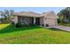 Beautiful single-story home featuring a well-manicured lawn, a two-car garage, and a screened front porch at 3524 Brownwood Ter, North Port, FL 34286