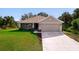 Charming single-story home featuring a well-manicured lawn, a two-car garage, and a screened front porch at 3524 Brownwood Ter, North Port, FL 34286