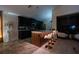 Modern eat-in-kitchen featuring an island with bar seating and an adjacent living room at 3524 Brownwood Ter, North Port, FL 34286