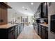 Contemporary kitchen features stylish cabinets, modern appliances, and an open layout connecting to the dining area at 3524 Brownwood Ter, North Port, FL 34286