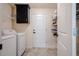 Laundry room features a washer, dryer, storage shelves, and a well-lit space at 3524 Brownwood Ter, North Port, FL 34286