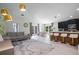Bright, open-concept living space with stylish furnishings, sleek black cabinets, and a dining area at 3524 Brownwood Ter, North Port, FL 34286