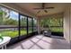 Screened-in porch featuring a ceiling fan, a barbecue and views of the lawn at 3524 Brownwood Ter, North Port, FL 34286