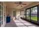 Screened-in porch with ceiling fan provides an outdoor lounge space overlooking the backyard at 3524 Brownwood Ter, North Port, FL 34286