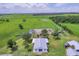 Aerial view of a white ranch style home and surrounding land at 39700 State Road 70 E, Myakka City, FL 34251