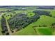 Aerial view of the rolling green land surrounding the home at 39700 State Road 70 E, Myakka City, FL 34251