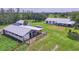 Aerial view of horse barn and fenced pastures offering great space for livestock at 39700 State Road 70 E, Myakka City, FL 34251