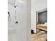 Luxurious shower with marble tile, a built-in bench, and modern fixtures adjacent to bedroom at 39700 State Road 70 E, Myakka City, FL 34251