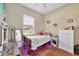 Neutral toned bedroom with tile floors and LED lighting beneath the bed and natural light from the window at 39700 State Road 70 E, Myakka City, FL 34251