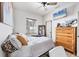 Cozy bedroom featuring a window view, a wooden dresser, ceiling fan, and ample natural light at 39700 State Road 70 E, Myakka City, FL 34251