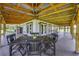Expansive covered patio with open beam ceiling and view of the property's landscaping at 39700 State Road 70 E, Myakka City, FL 34251