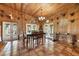 Open dining room boasting tile floors, a chandelier, wood paneling, and multiple access points to the outdoors at 39700 State Road 70 E, Myakka City, FL 34251