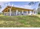 Sprawling ranch-style house features a beautiful covered porch and well-maintained lawn at 39700 State Road 70 E, Myakka City, FL 34251