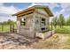 Exterior view of wooden structure with windows featuring drinking trough and mature trees at 39700 State Road 70 E, Myakka City, FL 34251