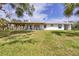 Back of the ranch-style house features a lovely covered porch and expansive backyard at 39700 State Road 70 E, Myakka City, FL 34251