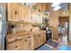 Efficient kitchen featuring stainless steel appliances, warm wood cabinetry, and tile flooring for a cozy feel at 39700 State Road 70 E, Myakka City, FL 34251