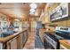 Charming kitchen with stainless appliances, wood cabinetry, and tile floors, great for cooking and entertaining at 39700 State Road 70 E, Myakka City, FL 34251