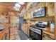 Well-appointed kitchen featuring stainless appliances, wood cabinets and countertops, with tile flooring at 39700 State Road 70 E, Myakka City, FL 34251