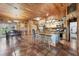 Spacious kitchen with stainless appliances, wood cabinetry, metal island with bar, and tile flooring throughout at 39700 State Road 70 E, Myakka City, FL 34251