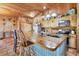 Charming kitchen featuring stainless appliances, custom wood cabinets, a corrugated metal island and tile flooring at 39700 State Road 70 E, Myakka City, FL 34251