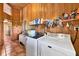 Cozy rustic laundry room, featuring modern appliances, wood accents, and tile flooring at 39700 State Road 70 E, Myakka City, FL 34251