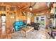 Cozy living room with comfortable sofas, tile flooring, wood paneling, and natural light, perfect for relaxing at 39700 State Road 70 E, Myakka City, FL 34251