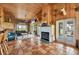 Spacious living room with fireplace, tile floors, wood paneling, and views of the outdoors at 39700 State Road 70 E, Myakka City, FL 34251