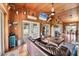 Spacious living room with wood paneling, tile floors, a fireplace, and abundant natural light at 39700 State Road 70 E, Myakka City, FL 34251