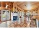 Bright living room featuring a fireplace, tile floors, wood paneling and multiple access points at 39700 State Road 70 E, Myakka City, FL 34251