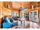 Inviting living room with comfortable seating, tile flooring, wood accents, and natural light from exterior doors at 39700 State Road 70 E, Myakka City, FL 34251