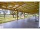 Spacious outdoor patio with a metal roof, and a serene backyard, perfect for entertaining at 39700 State Road 70 E, Myakka City, FL 34251