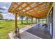 View of the covered porch that spans the back of the house and looks out to a pasture at 39700 State Road 70 E, Myakka City, FL 34251