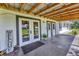 Covered porch with a Welcome sign, tiled floor, and white support beams at 39700 State Road 70 E, Myakka City, FL 34251