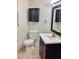 Compact bathroom with a vanity, updated fixtures, and a wall mounted cabinet at 4112 Cochise Ter, Sarasota, FL 34233