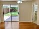 Sunny bedroom with hardwood floors, sliding glass doors to backyard, and ensuite bathroom access at 4112 Cochise Ter, Sarasota, FL 34233
