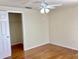 Bright bedroom features a ceiling fan, wood floors, and an open closet at 4112 Cochise Ter, Sarasota, FL 34233