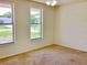 Bedroom with two windows and neutral carpet at 4112 Cochise Ter, Sarasota, FL 34233
