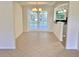 Bright dining area featuring glass doors to backyard, chandelier, and open access to kitchen at 4112 Cochise Ter, Sarasota, FL 34233